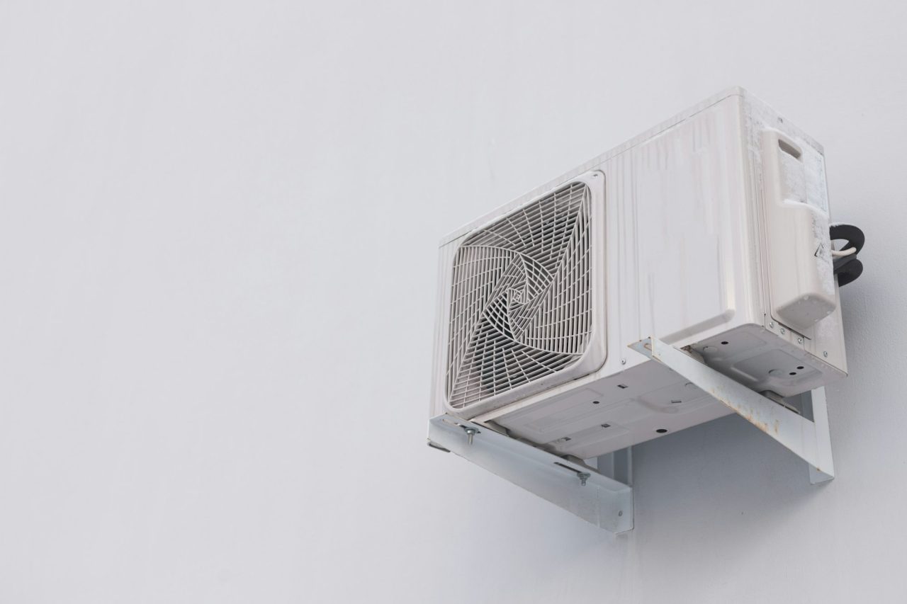 outdoor-air-conditioner-split-system-unit-on-white-wall-with-copy-space.jpg